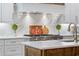 Close-up of a kitchen range with white cabinets and marble backsplash and countertops at 404 Club Dr., Myrtle Beach, SC 29572