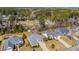 Expansive aerial view of homes with well-manicured lawns in a wooded neighborhood at 4208 Edgefield Rd., Little River, SC 29566