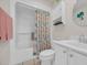 Clean bathroom with a white vanity, and a shower with a decorative curtain at 4208 Edgefield Rd., Little River, SC 29566