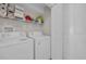 Bright laundry room with white appliances and storage shelf for detergents and cleaning supplies at 4208 Edgefield Rd., Little River, SC 29566