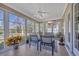 Enclosed sunroom with ceiling fan, lots of windows and outdoor views creates a relaxing space at 4208 Edgefield Rd., Little River, SC 29566