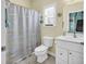Bright bathroom featuring a shower-tub combo, a vanity with storage, and a window for natural light at 4350 Grande Harbour Blvd., Little River, SC 29566
