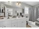 Bright bathroom with double sink vanity, large mirror, and shower-tub combination at 4350 Grande Harbour Blvd., Little River, SC 29566