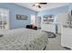 Airy bedroom with blue walls, a flat-screen TV, and a comfortable seating area at 4350 Grande Harbour Blvd., Little River, SC 29566