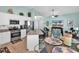 Open-concept kitchen with white cabinetry, stainless steel appliances, and granite countertops overlooking the living area at 4350 Grande Harbour Blvd., Little River, SC 29566