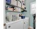 Well-organized laundry room with shelving, a washer, and a dryer for convenient laundry tasks at 4350 Grande Harbour Blvd., Little River, SC 29566