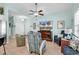 Cozy living room featuring a ceiling fan, tile flooring, and a large flat-screen television for entertainment at 4350 Grande Harbour Blvd., Little River, SC 29566