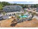 An aerial view showcases a condominium complex with a pool surrounded by palm trees at 4503 W Harbour Ct. # S-12, Little River, SC 29566