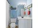 Clean bathroom featuring a white vanity, toilet, shower curtain, and light fixtures at 4503 W Harbour Ct. # S-12, Little River, SC 29566