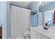 Bright bathroom with white vanity, shower curtain, and black fixtures at 4503 W Harbour Ct. # S-12, Little River, SC 29566