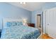 Bright bedroom with blue walls, a queen bed, hardwood floors, and attached bathroom at 4503 W Harbour Ct. # S-12, Little River, SC 29566