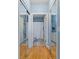 Hallway featuring hardwood floors, mirrors, and access to a full bathroom at 4503 W Harbour Ct. # S-12, Little River, SC 29566
