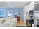 Kitchen with white cabinets, stainless appliances, with a view to bedroom at 4503 W Harbour Ct. # S-12, Little River, SC 29566