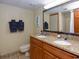 Bathroom featuring a double sink vanity with granite countertops, a large mirror, and tile flooring at 4800 S Ocean Blvd. # 1418, North Myrtle Beach, SC 29582