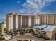 Expansive exterior view of Beach Cove Resort, showcasing its multi-story design and proximity to the ocean at 4800 S Ocean Blvd. # 1418, North Myrtle Beach, SC 29582