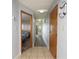 Hallway with tile flooring leading to a bedroom with bright and colorful furnishings at 4800 S Ocean Blvd. # 1418, North Myrtle Beach, SC 29582