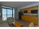 Condo kitchenette with wooden cabinets, black appliances, and access to balcony with ocean view at 4800 S Ocean Blvd. # 1418, North Myrtle Beach, SC 29582