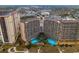 Aerial view of a complex, featuring a large swimming pool area surrounded by resort buildings at 4800 S Ocean Blvd. # 1418, North Myrtle Beach, SC 29582