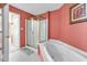 Bathroom with a soaking tub, shower, and salmon colored walls for a unique look at 4814 Innisbrook Ct. # 412, Myrtle Beach, SC 29579