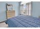 Comfortable bedroom featuring a blue comforter, carpet, a large window, and light blue walls at 4814 Innisbrook Ct. # 412, Myrtle Beach, SC 29579