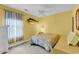 Comfortable bedroom with yellow walls, a fish decoration and a window letting in natural light at 4814 Innisbrook Ct. # 412, Myrtle Beach, SC 29579