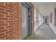 Brick building exterior featuring an elevator, white railing, and entrance door at 4814 Innisbrook Ct. # 412, Myrtle Beach, SC 29579