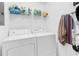 Well lit laundry room with washer, dryer, wire rack and household cleaning and laundry supplies at 4814 Innisbrook Ct. # 412, Myrtle Beach, SC 29579