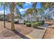 View of the pool house featuring manicured landscaping with palm trees, and a white fence at 4814 Innisbrook Ct. # 412, Myrtle Beach, SC 29579