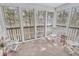 Enclosed sunroom features three chairs with a nice view of the surrounding trees at 4814 Innisbrook Ct. # 412, Myrtle Beach, SC 29579
