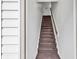 An interior staircase with carpeted steps and a wooden handrail provides access to the upper level at 500 Fairway Village Dr. # 7-D, Myrtle Beach, SC 29588
