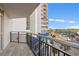 This condo boasts a private balcony overlooking a street and palm trees, with a metal safety railing at 504 N Ocean Blvd. # 401, Myrtle Beach, SC 29577