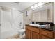 Clean bathroom with a shower-tub combo, vanity, and large mirror for a bright and open feel at 504 N Ocean Blvd. # 401, Myrtle Beach, SC 29577