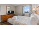 Relaxing bedroom with a dresser, TV, and a view of the outside from the window at 504 N Ocean Blvd. # 401, Myrtle Beach, SC 29577