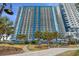High-rise building with balconies and palm trees provides appealing oceanfront condos and vacation rentals at 504 N Ocean Blvd. # 401, Myrtle Beach, SC 29577