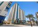 Tall condo building showcasing multiple balconies and a modern blue and white design at 504 N Ocean Blvd. # 401, Myrtle Beach, SC 29577