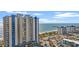 Coastal high-rise condo featuring ocean views, a parking lot, and a pier in the distance at 504 N Ocean Blvd. # 401, Myrtle Beach, SC 29577