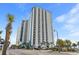 Stunning high-rise condo building featuring balconies, palm trees, and street access at 504 N Ocean Blvd. # 401, Myrtle Beach, SC 29577