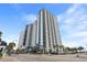 High-rise condo building with balconies and palm trees provides an appealing oceanfront vacation rental destination at 504 N Ocean Blvd. # 401, Myrtle Beach, SC 29577