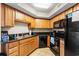 The kitchen features wooden cabinets, black appliances, and stone countertops at 504 N Ocean Blvd. # 401, Myrtle Beach, SC 29577