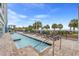 Outdoor pool with lounge chairs near beach and palm trees offering a relaxing vacation experience at 504 N Ocean Blvd. # 401, Myrtle Beach, SC 29577