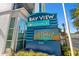 Bay View on the Boardwalk Resort sign showing unit number and time with palm trees and white building at 504 N Ocean Blvd. # 401, Myrtle Beach, SC 29577