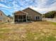 Backyard featuring a screened porch and white picket fence; ideal for outdoor entertaining at 511 Mattamushkeet Dr., Little River, SC 29566