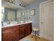 Bright bathroom features a double sink vanity with dark wood cabinets and a tiled floor at 511 Mattamushkeet Dr., Little River, SC 29566