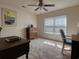 Bright bedroom with neutral carpet features a ceiling fan and natural light from the window at 511 Mattamushkeet Dr., Little River, SC 29566