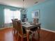 Elegant dining room with a chandelier, seating for six, and a serene ambiance for Gathering meals at 511 Mattamushkeet Dr., Little River, SC 29566
