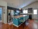 Modern kitchen featuring a large center island, stainless appliances, and hardwood floors at 511 Mattamushkeet Dr., Little River, SC 29566