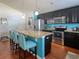 Well-appointed kitchen featuring dark cabinetry, granite counters, and stainless steel appliances at 511 Mattamushkeet Dr., Little River, SC 29566