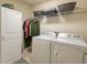 Laundry room features a full sized washer and dryer, shelving and storage space at 511 Mattamushkeet Dr., Little River, SC 29566