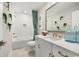 Modern bathroom with a tub, white vanity with gold fixtures, and stylish decor at 512 9Th Ave. S, North Myrtle Beach, SC 29582