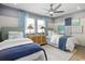 Bright bedroom with two beds, decorative accents, and a ceiling fan at 512 9Th Ave. S, North Myrtle Beach, SC 29582